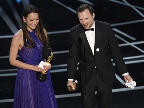 Joanna Natasegara, left, and Orlando von Einsiedel accept the award for best documentary short subject for &ampquot;The White Helmets&ampquot; at the Oscars on Sunday, Feb. 26, 2017, at the Dolby Theatre in Los Angeles. (Photo by Chris Pizzello/Invision/AP)