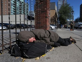 A man sleeps on the street near the Salvation Army on George Street in October. (Photo: Tony Caldwell)