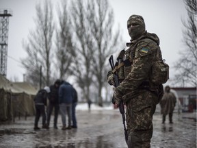 A Ukrainian serviceman patrols at the humanitarian aid center in Avdiivka, Ukraine, Saturday, Feb. 4, 2017. Fighting in eastern Ukraine sharply escalated this week. Ukraine's military said several soldiers were killed over the past day in shelling in eastern Ukraine, where fighting has escalated over the past week.