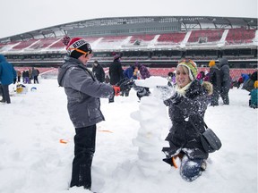 Clark McEachran, 6, and   Emma McEachran  were among hundreds of people at Lansdowne Park Saturday trying to beat a world record for snowman building.