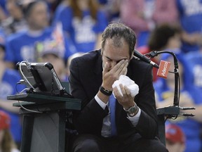 Umpire Arnaud Gabas of France holds his face after being hit by a ball during first round Davis Cup tennis action between Canada's Denis Shapovalov and Great Britain's Kyle Edmund, Sunday, Feb. 5, 2017 in Ottawa.