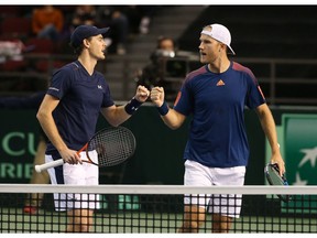 Jamie Murray and Dominic Inglot of Great Britain fist-bump after winning a set point against Vasek Pospisil and Daniel Nestor of Canada during the doubles match on day two of the Davis Cup World Group tie between Great Britain and Canada at TD Place Arena on February 4, 2017 in Ottawa, Ontario, Canada.