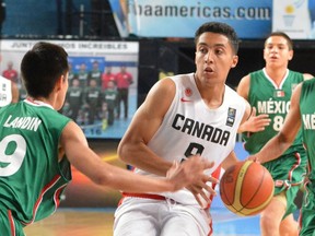 Canada's Noah Kirkwood of Ottawa, centre, drives through traffic in a game against Mexico at the 2015 FIBA Americas boys' U16 basketball championship in Argentina.