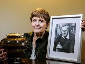 Christine McMullan with a photo of her late husband Bruce and an urn containing his ashes.