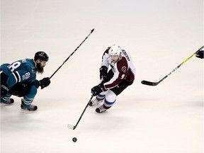 SAN JOSE, CA - JANUARY 21:  Matt Duchene #9 of the Colorado Avalanche skates between Brent Burns #88 and Paul Martin #7 of the San Jose Sharks at SAP Center on January 21, 2017 in San Jose, California.