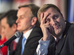 Leadership hopeful Brad Trost, sitting at one end of the stage, views the action on a projection screen at the Conservative leadership candidates' debate, in Halifax on Saturday, Feb. 4, 2017.