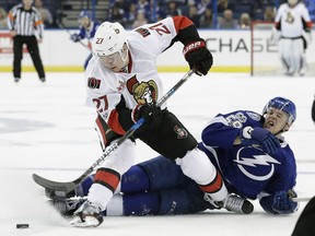 Tampa Bay Lightning defenseman Jake Dotchin (59) takes down Ottawa Senators right wing Curtis Lazar (27) during the third period of an NHL hockey game Thursday, Feb. 2, 2017, in Tampa, Fla. The Senators won 5-2.