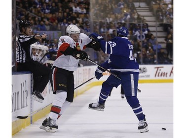The Senators' Dion Phaneuf and Nazem Kadri of the Leafs bounce off each other.