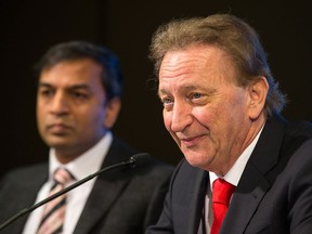 Dr Atul Humar (L) listens as Ottawa Senators owner Eugene Melnyk talk during a news conference at Canadian Tire Centre where a new charity organization known as "the organ project", dedicated to improving the access to organs for transplant, was announced.  Wayne Cuddington/ Postmedia