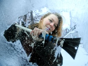 Eden Luciak has to put some muscle into scraping the layered, heavy ice off her car windows Wednesday  morning after Tuesday night's freezing rain storm.