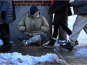 A man pandhandles on the frozen sidewalks along Elgin Street on Jan. 20.  (Julie Oliver / Ottawa Citizen)
