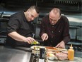 Fairouz restaurant chef Walid El-Tawel (L) works on a plate in his kitchen with Masterchef Canada judge Michael Bonacini. Wednesday December 7, 2016.