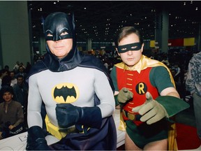 In this Jan. 27, 1989 file photo, actors Adam West, left, and Burt Ward dress as their characters Batman and Robin respectively during an appearance at the "World of Wheels" custom car show in Chicago.