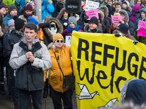 Former MP Paul Dewar addresses the crowd during an anti-Trump protest outside the Embassy of the United States in Ottawa. (Wayne Cuddington/Postmedia)