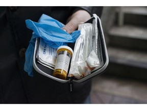 Garth Mullins holds a Naloxone anti-overdose kit in downtown Vancouver, Friday, Feb. 10, 2017.