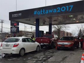 Montrealers line up for a free tank of gasoline on Tuesday, courtesy Ottawa 2017. The giveaway was to raise awareness that Ottawa is only a tank of gas away from Montreal.