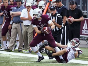 Receiver Mitchell Baines tries to elude Robbie Yochim of the McMaster Marauders during the Gee-Gees' regular-season game on Sept. 10, 2016.