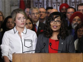 Liberal MP Iqra Khalid makes an announcement about an anti-Islamophobia motion on Parliament Hill while Minister of Canadian Heritage Melanie Joly looks on in Ottawa on Wednesday, February 15, 2017.