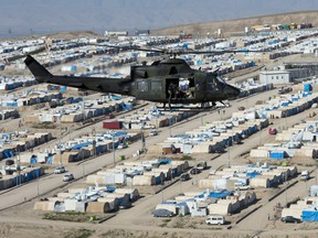 A Canadian Forces Griffon helicopter flies over a Internal Displaced persons camp near Erbil, Iraq, February 20, 2017. THE CANADIAN PRESS/Ryan Remiorz ORG XMIT: RYR112