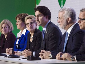 Prime Minister Justin Trudeau, shown here with the premiers in November, is still wrestling with some provinces over health care.