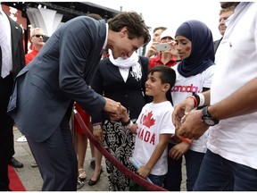 Prime Minister Justin Trudeau greets a Syrian refugee on Canada Day July 1, 2016. At this point, is it all just for show?
