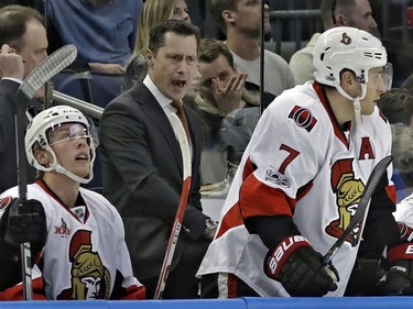 Ottawa Senators coach Guy Boucher, center, shouts at his players, including Kyle Turris, right, during the first period of the team's NHL hockey game against the Tampa Bay Lightning on Thursday, Feb. 2, 2017, in Tampa, Fla. Boucher is a former Lightning coach.