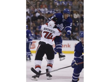 The Leafs' Nikita Shosnikov is hit by Mark Borowiecki.