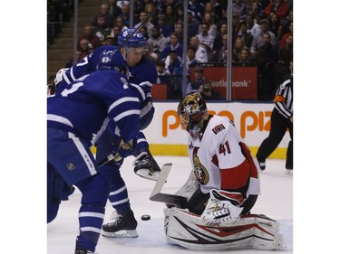 Leo Komarov provides a screen in front of Craig Anderson.
