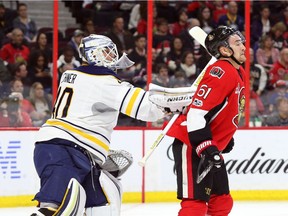 Mark Stone of the Ottawa Senators gets hit hard by Robin Lehner of the Buffalo Sabres during first period of NHL action at Canadian Tire Centre in Ottawa, February 14, 2017.