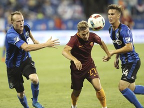 Federico Ricci (centre) of AS Roma chases after a ball in the second half of an international friendly soccer game Wednesday, August 3, 2016 against the Montreal Impact at Saputo stadium in Montreal as Thomas Meilleur-GiguËre (right) and Wandrille Lefevre pursue.