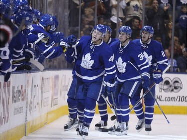 Morgan Rielly celebrates his goal with Leafs teammates.