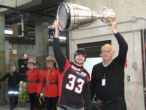 Ottawa Redblacks player Dan West of Cornwall and Cornwall football legend "Moe the Toe'' Racine with the Grey Cup   this month.