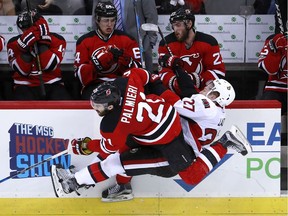 New Jersey Devils right wing Kyle Palmieri checks Ottawa Senators right wing Curtis Lazar during the third period of Tuesday's NHL game in Newark, N.J. The Senators won 2-1.