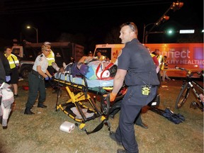 New Orleans emergency personnel attend to an injured parade watcher after a pickup truck plowed into a crowd injuring multiple people watching the Krewe of Endymion parade in the Mid-City section of New Orleans, Saturday, Feb. 25, 2017. Police Chief Michael Harrison says one person in custody and that he is being investigated for driving while intoxicated.