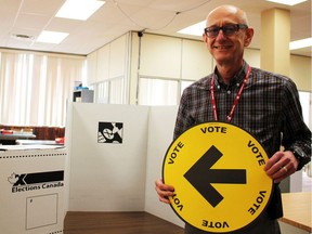 Niagara Centre's federal election returning officer Bob Diakow stands beside a polling station and ballot box, preparing for election day, on Thursday October 15, 2015 in Welland, Ont. Allan Benner/Welland Tribune/Postmedia Network