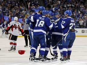 Ondrej Palat (18) and Jonathan Drouin (27) join teammates in celebrating with Nikita Kucherov, middle, on his third goal of the second period of Monday's game against the Senators.