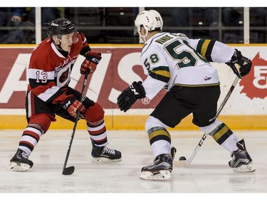 The 67's Artur Tyanulin tries to work the puck around the Knights' Mitchell Vande Sompel.