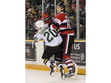 The Ottawa 67's Chris Martenet checks London's Adrian Carbonara.