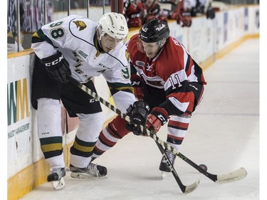 The Ottawa 67's David Pearce checks the London Knights' Victor Mete.