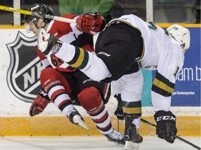 The Ottawa 67's Peter Stratis bounces off a hit by the London Knights' Cole Tymkin during OHL action at the TD Place arena on Monday, Feb. 20, 2017.