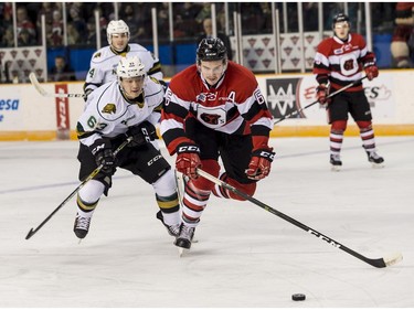 The 67's Ryan Orban eludes the check of the Knights' Cliff Pu.