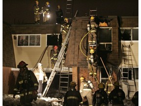 Firefighters at scene of fire at 1500 Caldwell Ave. on March 31, 2008. Khalid Ali, 2, died in the blaze.