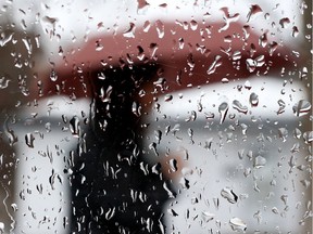 A lady walks in the rain in Ottawa Friday Feb 24, 2017.  Tony Caldwell