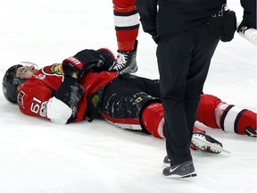 Ottawa Senators' Mark Stone (61) lies injured on the ice after being hit hard by Winnipeg Jets' Jacob Trouba (not shown) during third period NHL hockey action in Ottawa, Sunday February 19, 2017.