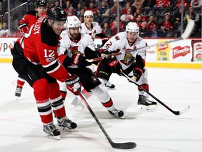 NEWARK, NJ - FEBRUARY 16:  Ben Lovejoy #12 of the New Jersey Devils heads for the net as Tom Pyatt #10 and Dion Phaneuf #2 of the Ottawa Senators defend on February 16, 2017 at Prudential Center in Newark, New Jersey.