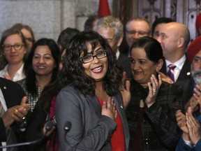 Liberal MP Iqra Khalid is welcomed by her colleagues as she arrives to make an announcement about an anti-Islamophobia motion on Parliament Hill in Ottawa on Wednesday, February 15, 2017. THE CANADIAN PRESS/ Patrick Doyle ORG XMIT: PD101