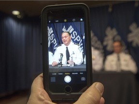 Montreal Chief of Police Philippe Pichet is recorded with a mobile device as he speaks about the tapping of a reporter's smartphone at a news conference last fall. A private bill in the Senate would strengthen protection of journalists and their confidential sources from such scrutiny.