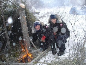 Ottawa police Sgt. Brad Hampson and Ottawa police Const. Louise Lafleur completing a lean-to survival shelter with fire to radiate heat inside during a winter survival training course in the Northwest Territories. The two officers headed to Nunavut, where they spent several weeks working with RCMP detachments there.