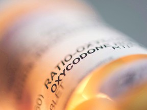 Prescription pill bottle containing oxycodone and acetaminophen is shown on June 20, 2012.