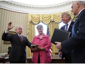 U.S. President Donald Trump watches as Jeff Sessions (L) is sworn in as the new U.S. attorney general. Will Sessions stand up for the integrity of the justice system, and for judges?